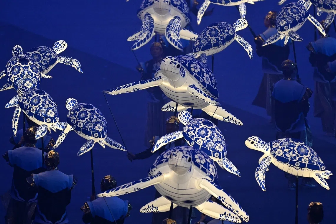 Performers from Soka Gakkai hoding puppets of sea animals during a performance by singer Asnida Daud during NDP 2026 on Aug 9.