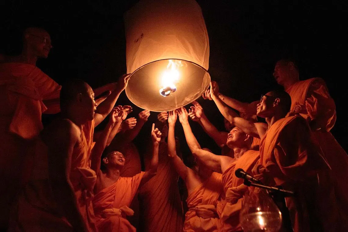 Buddhist monks releasing a lantern as a part of an annual ritual of Pabbaja Samanera, a 12-day long moral and spiritual training for prospective monks, at the Borobudur temple in Magelang, Central Java, Indonesia, on Dec 23, 2023. 