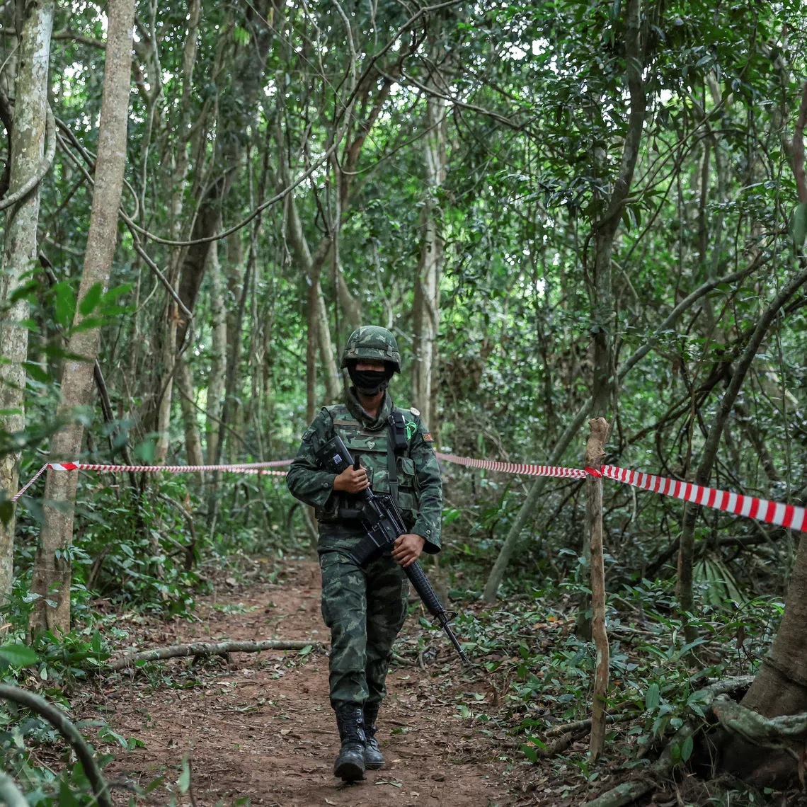 A Thai military personnel walks near the Thai-Cambodian border at Chong Chub Ta Mok area, in Surin province, Thailand, on Aug 20.