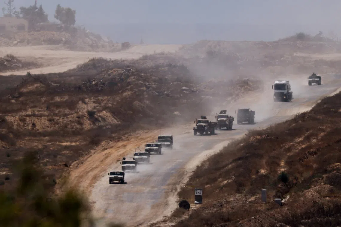 FILE PHOTO: An Israeli military convoy moves inside the Gaza Strip, amid the ongoing conflict between Israel and Hamas, as seen from Israel, June 17, 2024. REUTERS/Amir Cohen/File Photo