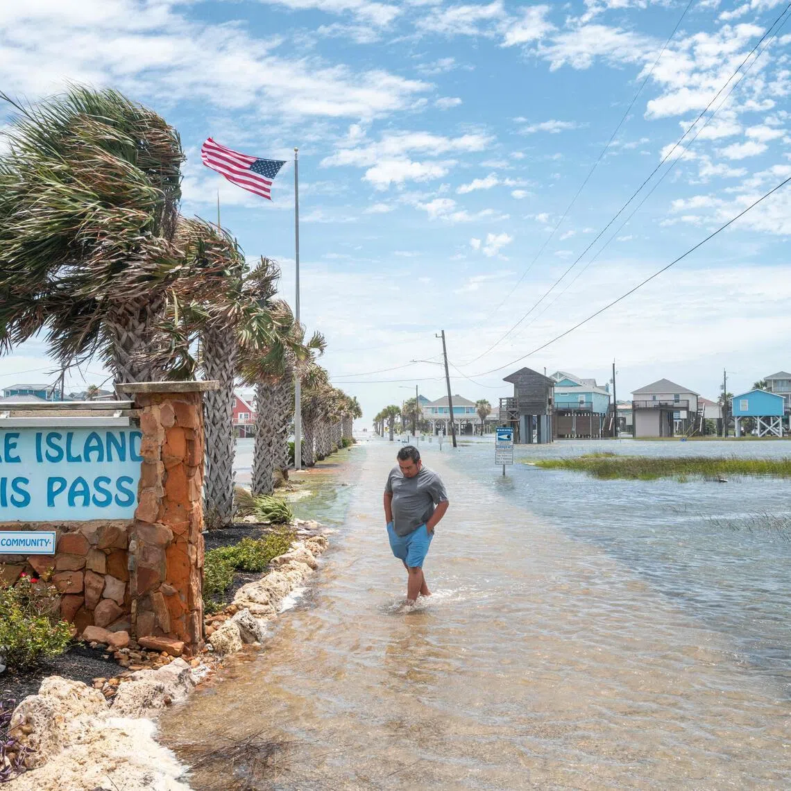 FREEPORT, TEXAS - JUNE 17: A person walks through a flooded neighborhood after Tropical Storm Arthur made landfall on June 17, 2026 in Freeport, Texas. A Tropical Storm Watch has been issued for portions of the northwestern Gulf Coast, stretching from the mid-to-upper Texas coast into Louisiana, as Tropical Storm Arthur brought heavy downpour and flooding. Tropical Storm Arthur becomes the first named storm of the Atlantic hurricane season.   Brandon Bell/Getty Images/AFP (Photo by Brandon Bell / GETTY IMAGES NORTH AMERICA / Getty Images via AFP)