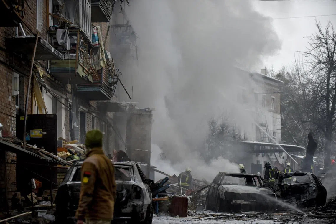 Firefighters work at the site of an apartment block destroyed by Russian shelling in Vyshhorod, near Kyiv, on Nov 23, 2022. 