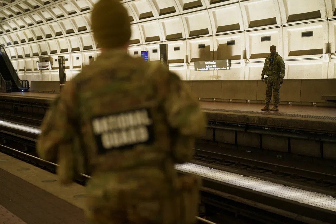 Members of the National Guard patrol the Smithsonian Metro Station after two National Guard members were shot on Wednesday, in Washington, D.C., U.S., November 28, 2025. REUTERS/Nathan Howard