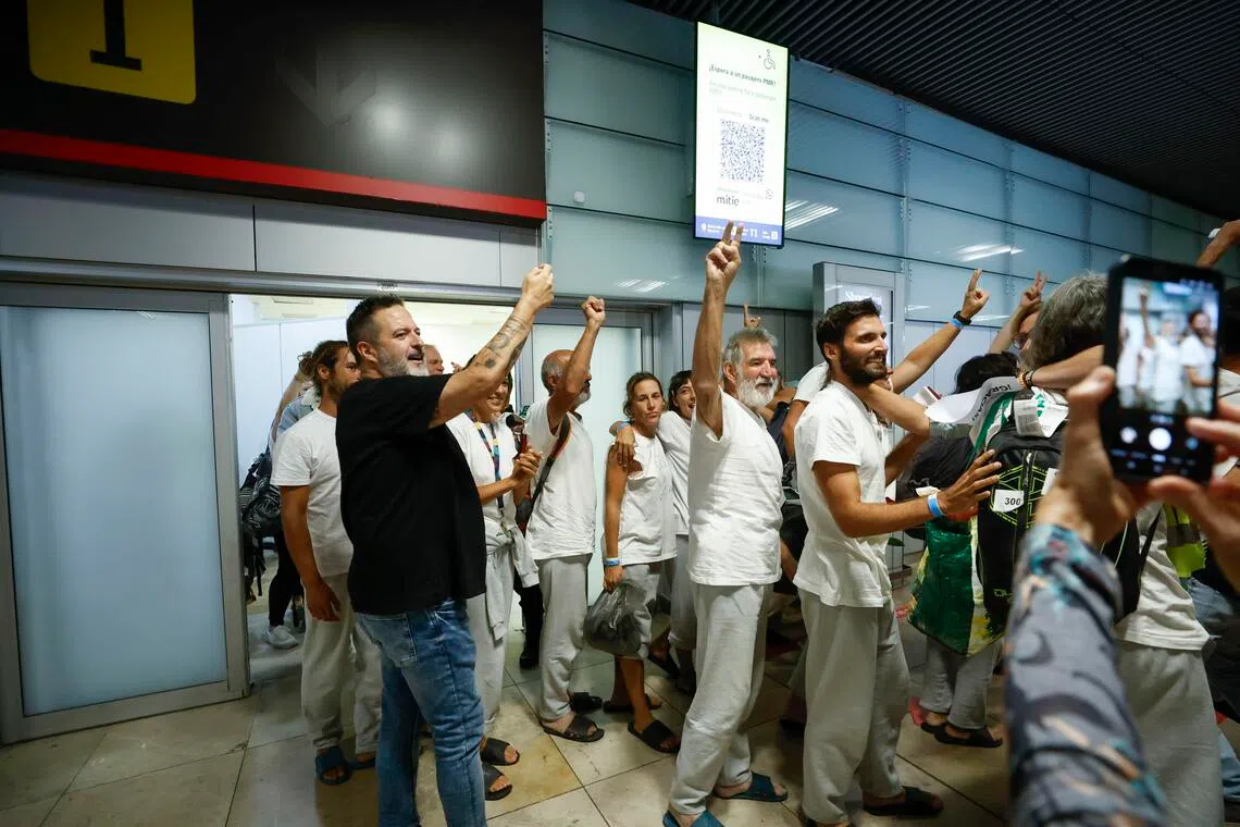Twenty-one Spanish activists who were among the Global Sumud Flotilla's crew members detained by Israeli forces arrive at Adolfo Suarez Madrid-Barajas airport, in Madrid, Spain on Oct 5, 2025.