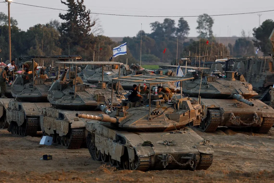 Tanks parked near the Israel-Gaza border, amid the Israel-Hamas conflict, as seen from Israel, July 21, 2024. REUTERS/Amir Cohen