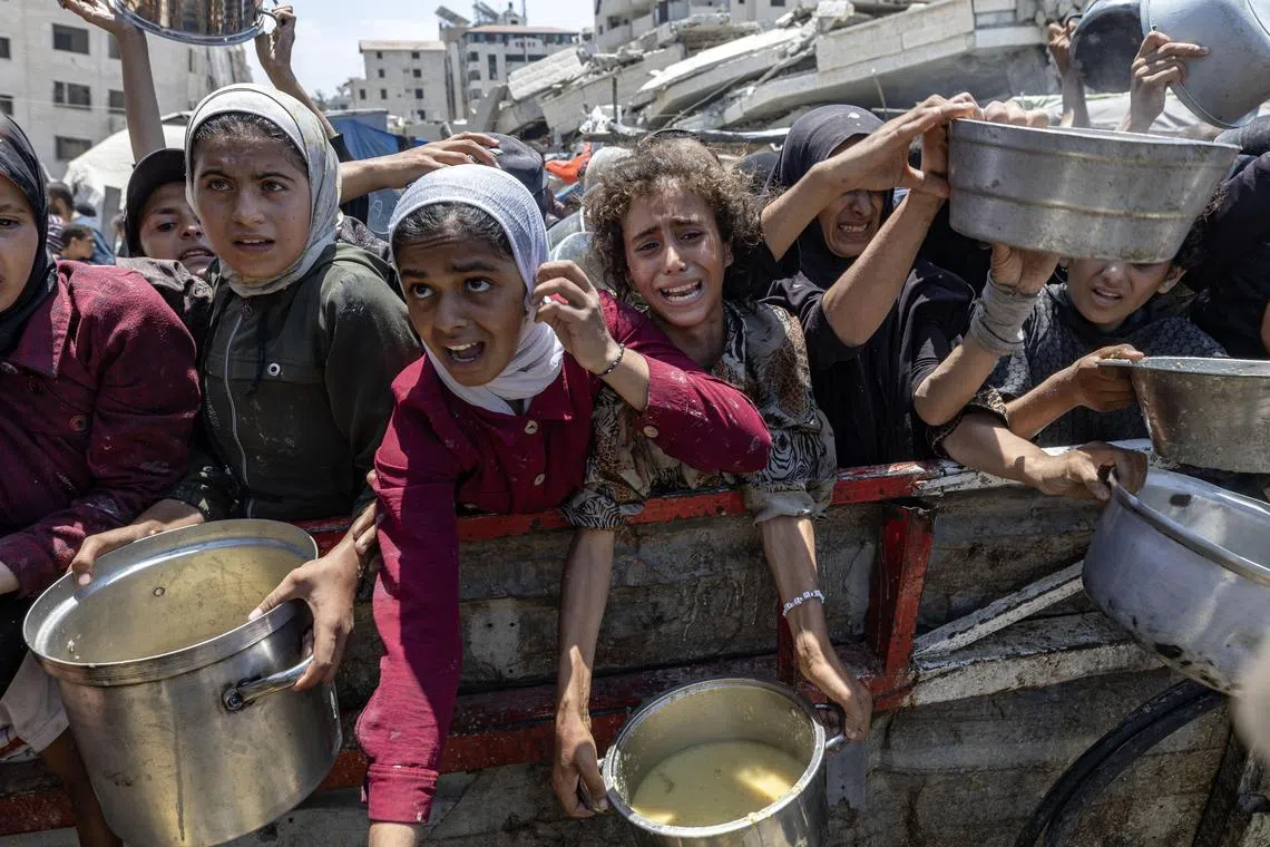 Palestinians at a charity kitchen in Gaza City on Aug 2.