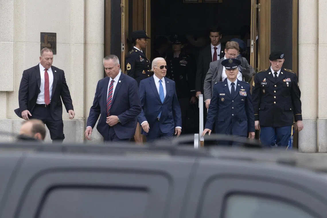 US President Joe Biden (centre) leaves the  Walter Reed National Military Medical Centre after undergoing his annual physical exam.