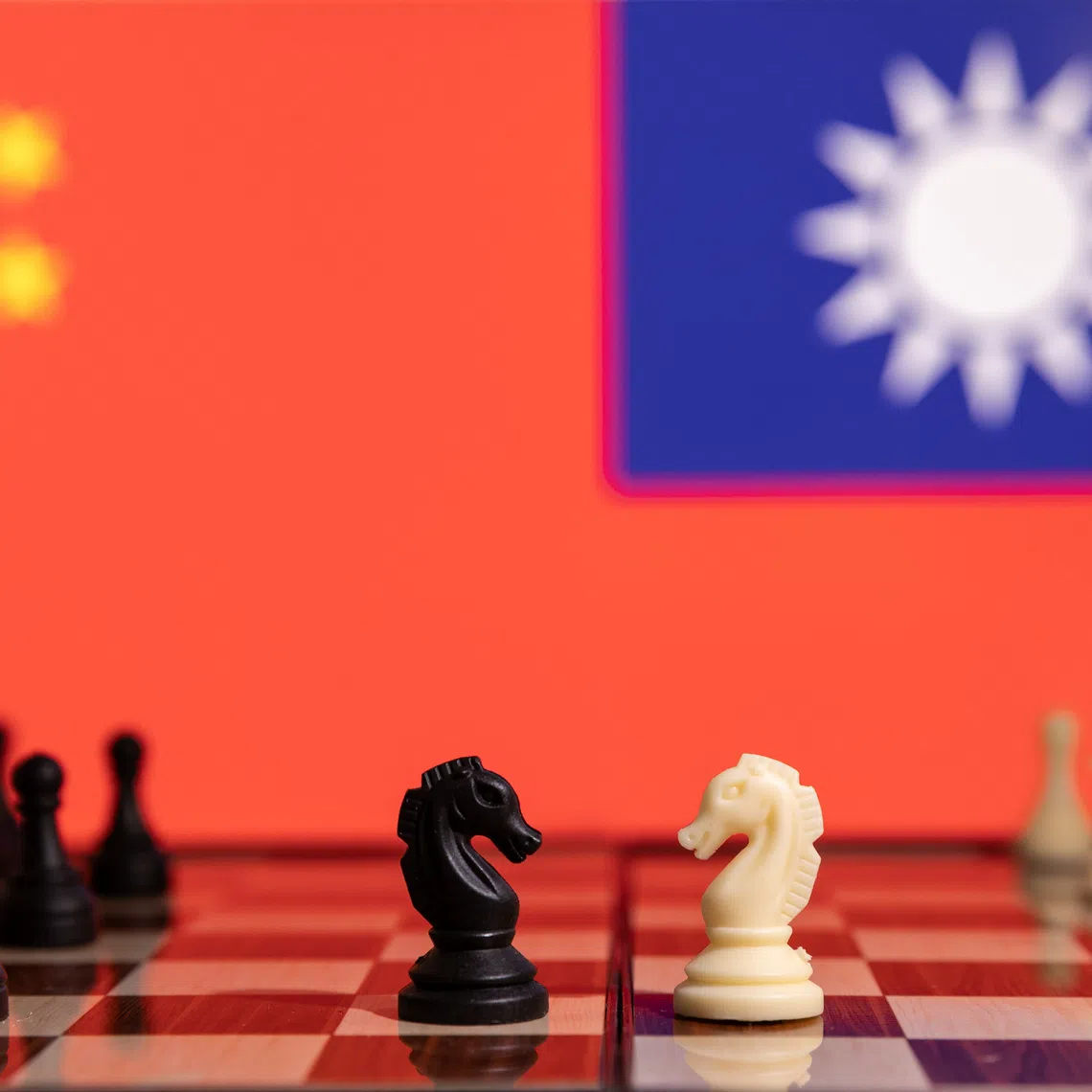 Chess pieces are seen in front of displayed China and Taiwan's flags in this illustration taken January 25, 2022. REUTERS/Dado Ruvic/Illustration