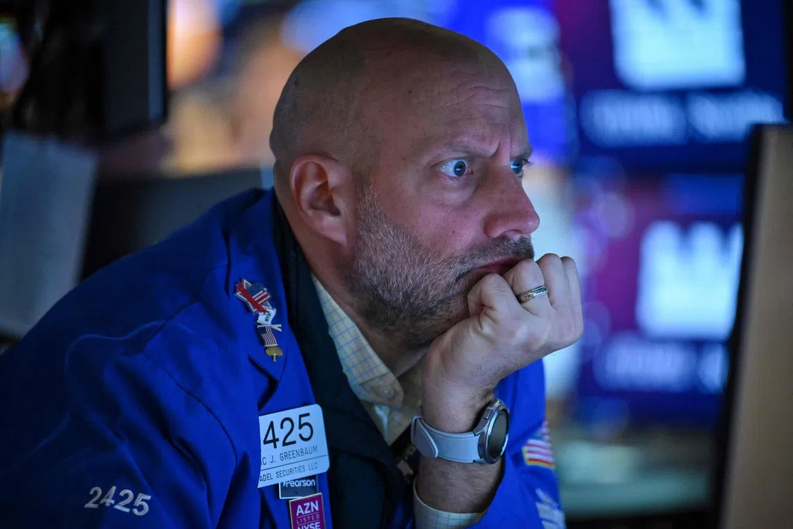 A trader works on the floor of the New York Stock Exchange at the opening bell in New York City on Oct 19.