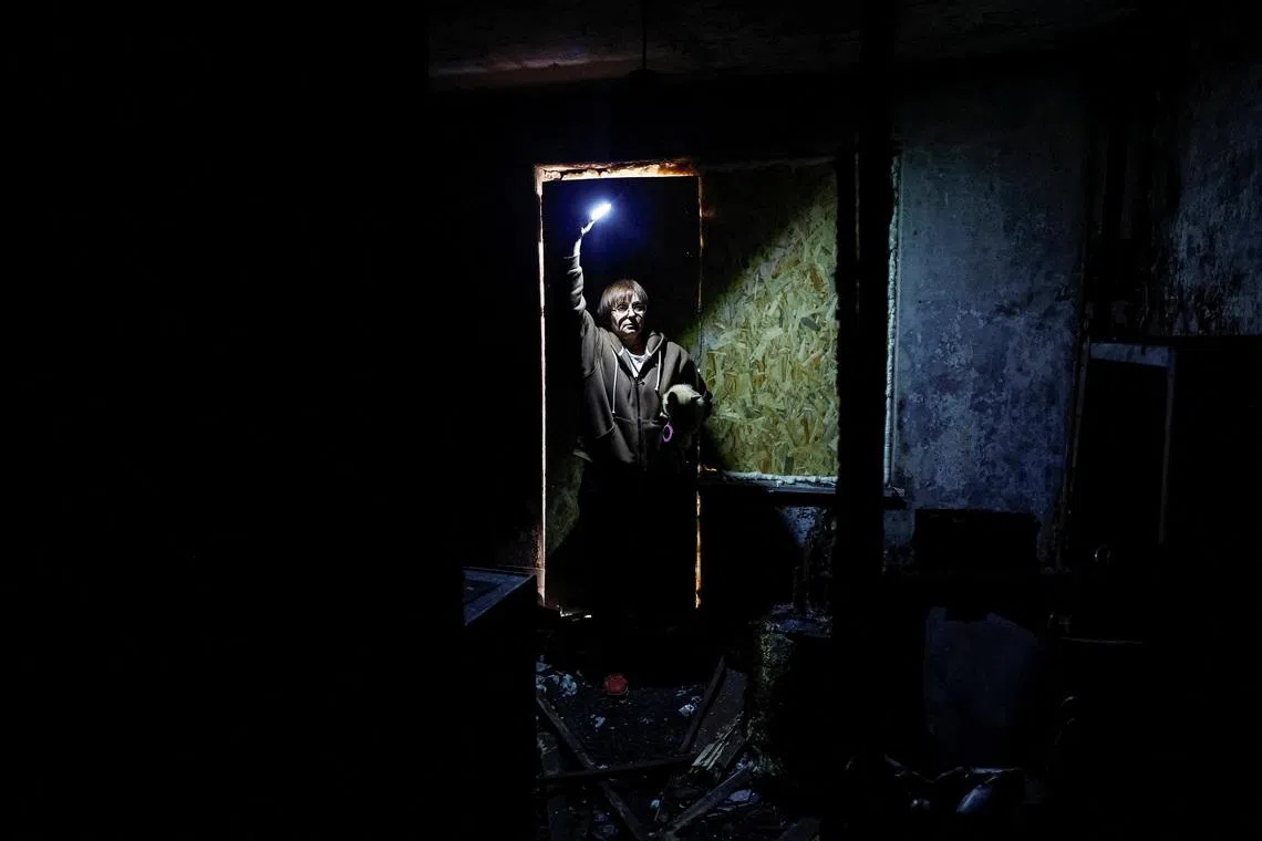 Valentyna Ananenko, 58, wife of Oleksii Ananenko, a Hero of Ukraine for his role in a 1986 mission beneath the fourth Chernobyl reactor, visiting the burnt-out apartment of her neighbour Nataliia Khodemchuk, 73, who was killed in a Russian drone strike on Nov 14, 2025, ahead of the 40th anniversary of the Chernobyl disaster, amid Russia's attack on Ukraine, in Kyiv, Ukraine, April 20.