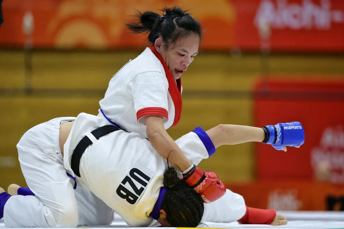 Tiffany Teo of Singapore in action against Khilola Sobirova of Uzbekistan during the mixed martial arts women’s traditional (60kg) final of the Asian Games at the Nagoya City Inae Sports Centre on Sept 22.