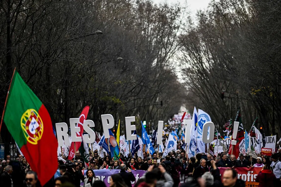 Teachers hold big letters reading "respect" as they demonstrate for better wages in Lisbon on Feb 11, 2023. 
