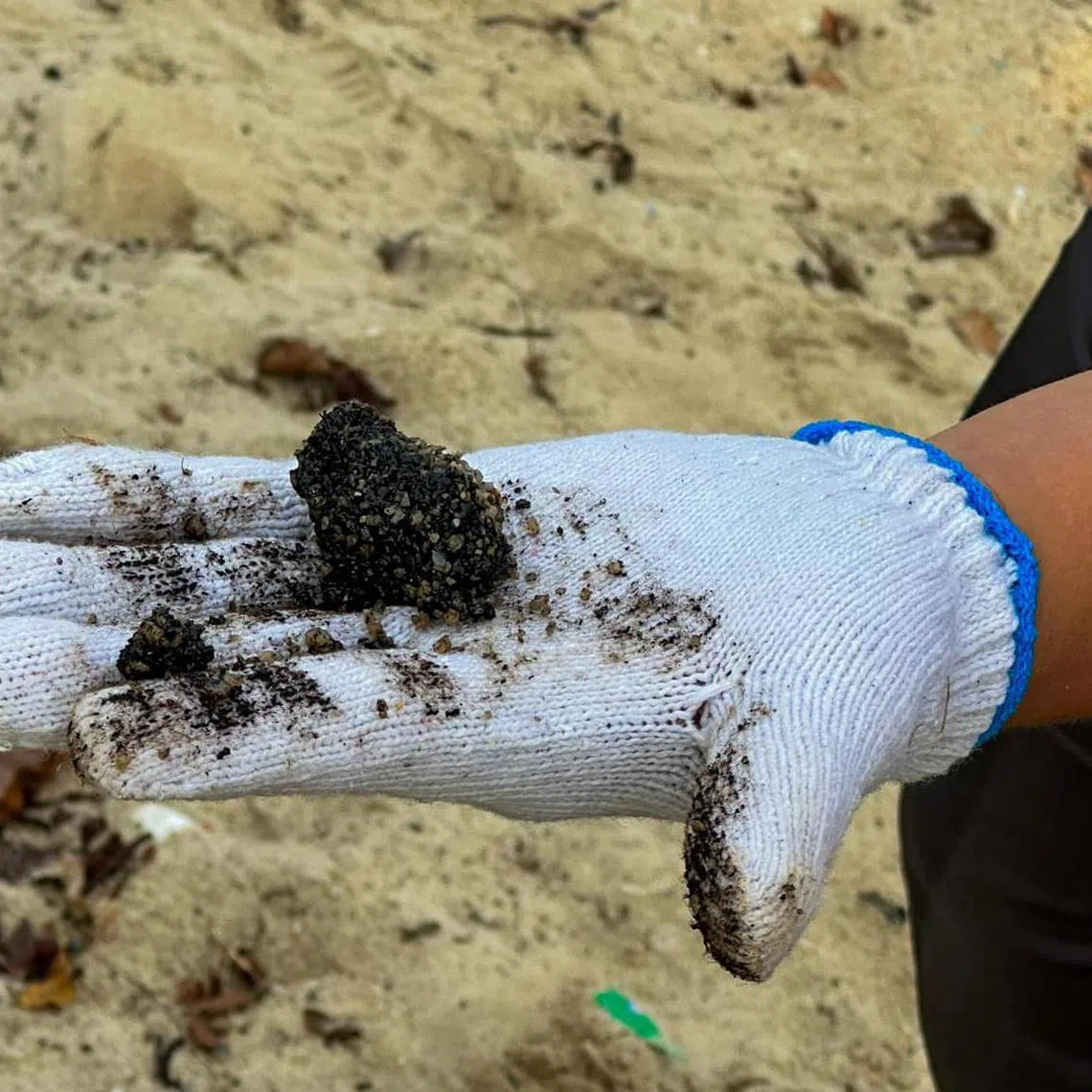 Tar balls are coagulated oil deposits mixed with sand must be manually removed from sand using tools like rakes or sieves, and can range in size from a fingernail to a fist. 