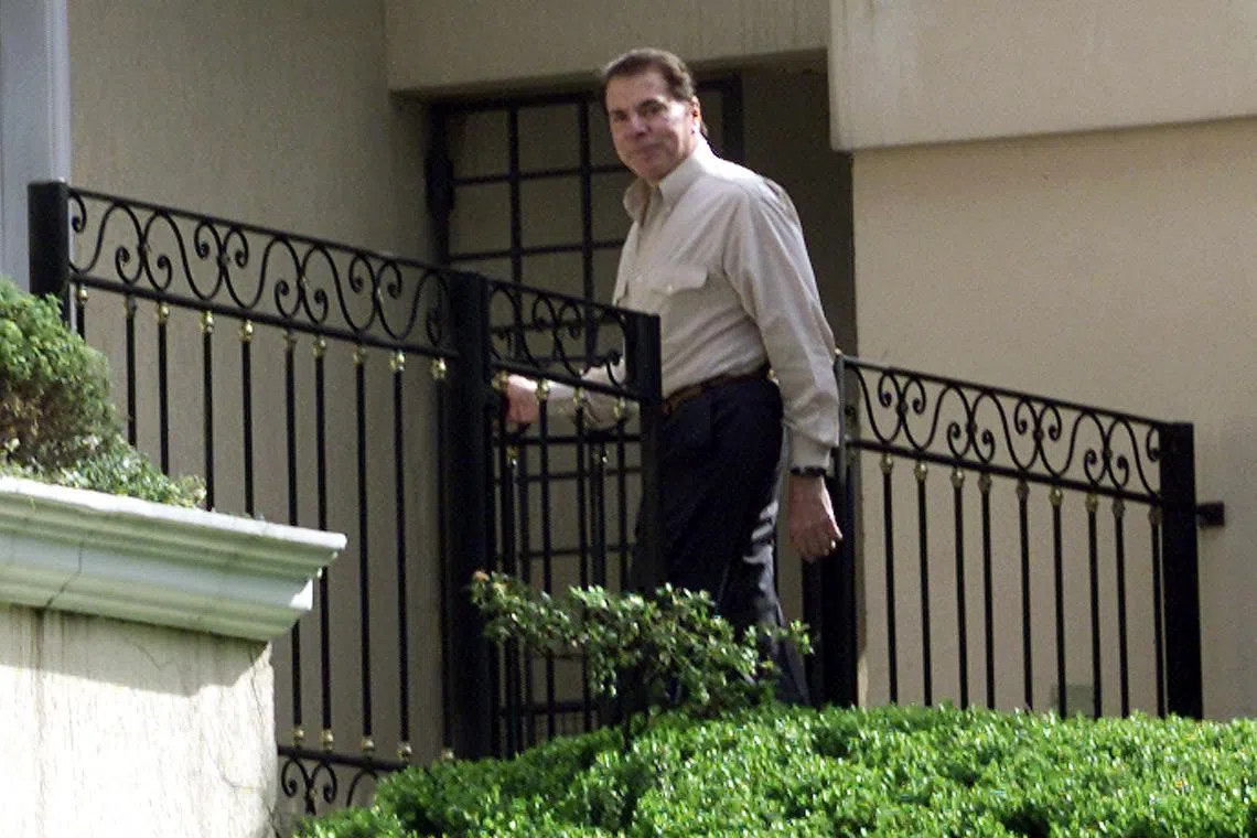 Brazilian media mogul Silvio Santos in front of his mansion in Sao Paulo, August 30, 2001. REUTERS/Paulo Whitaker/File Photo