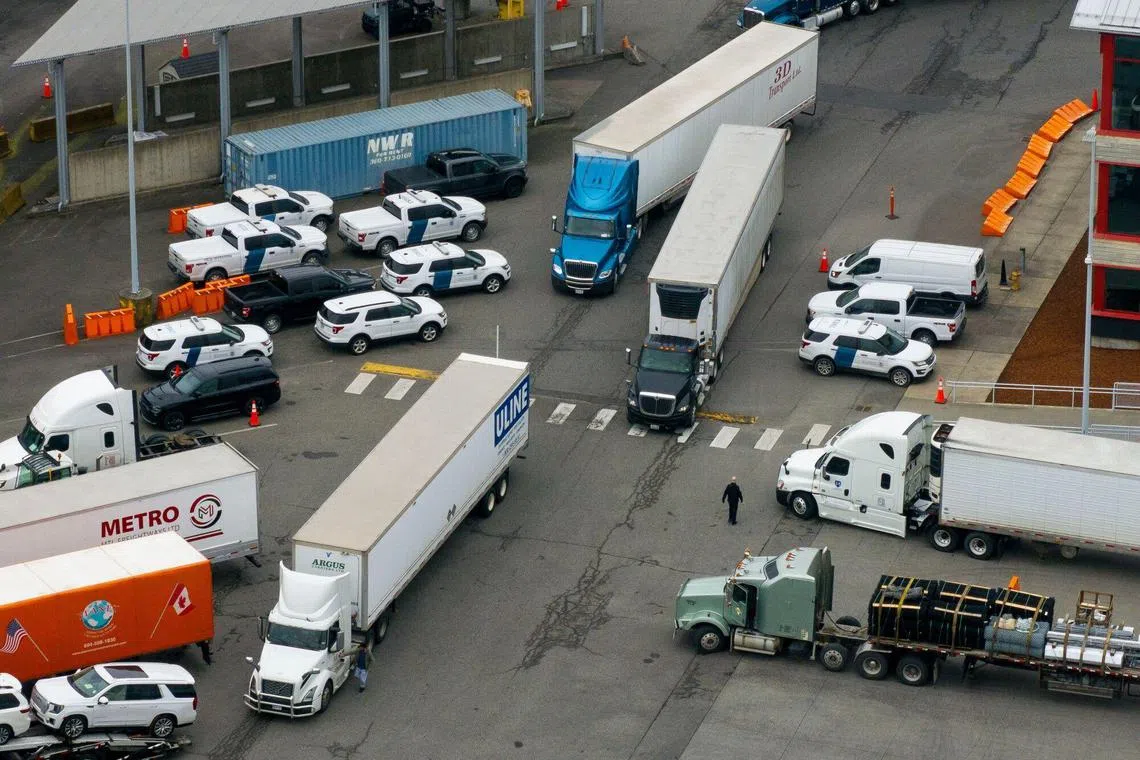 Tractor trailers entering the US from Canada at the Pacific Highway Border Crossing in Blaine, Washington, US, on Monday, March 3, 2025. US President Donald Trump said he would plow ahead with new tariffs on Canada and Mexico starting Tuesday, a broadside against the two biggest US trading partners that underscores his push to remake global trade. Photographer: David Ryder/Bloomberg