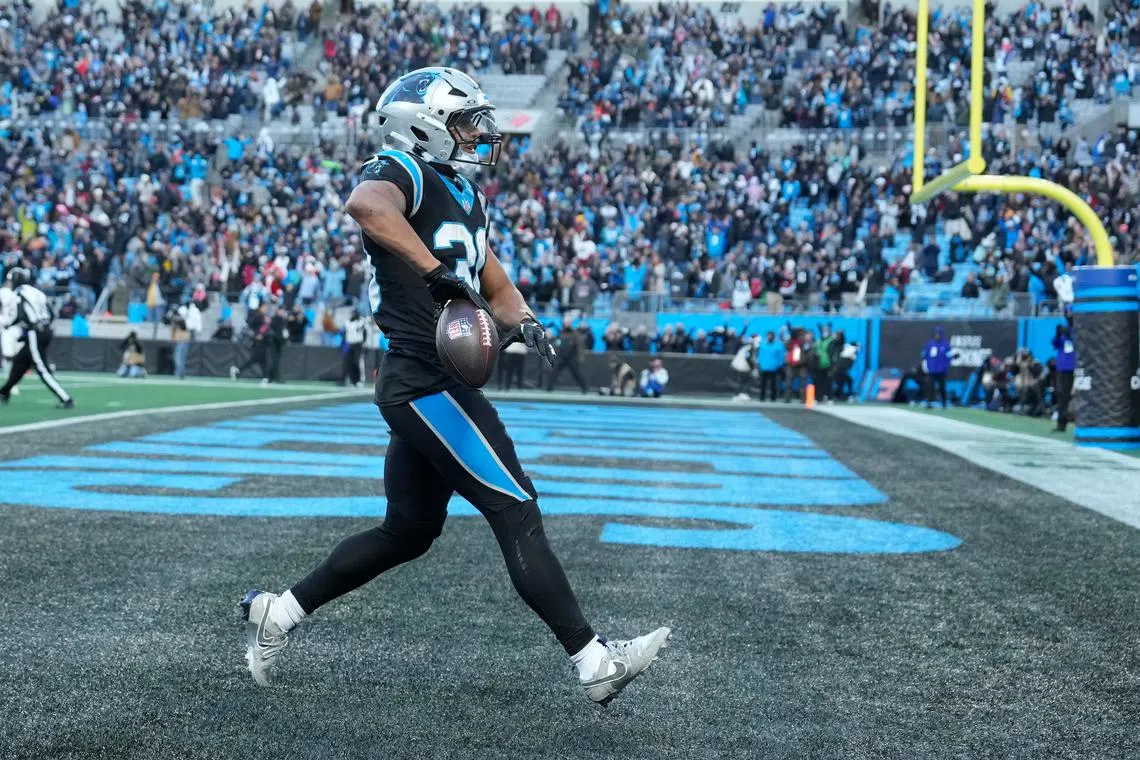 Dec 22, 2024; Charlotte, North Carolina, USA; Carolina Panthers running back Chuba Hubbard (30) scores in overtime to win the gqme at Bank of America Stadium. Bob Donnan-Imagn Images/File Photo