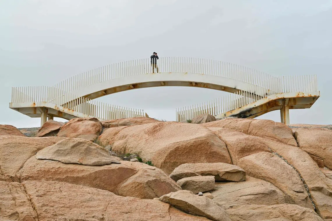 A man taking picture at a scenic spot called 68 Nautical Miles on Pingtan island, the closest point in China to Taiwan's main island, in China's Southeast Fujian province, on Dec 10, 2024. 