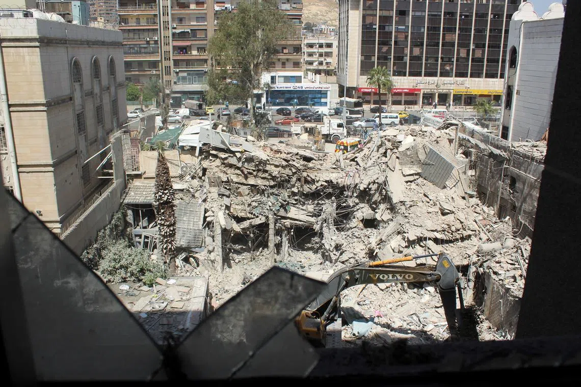 An excavator clears rubble after a suspected Israeli strike on Monday on Iran's consulate, adjacent to the main Iranian embassy building, which Iran said had killed seven military personnel including two key figures in the Quds Force, in the Syrian capital Damascus, Syria April 2, 2024. REUTERS/Firas Makdesi