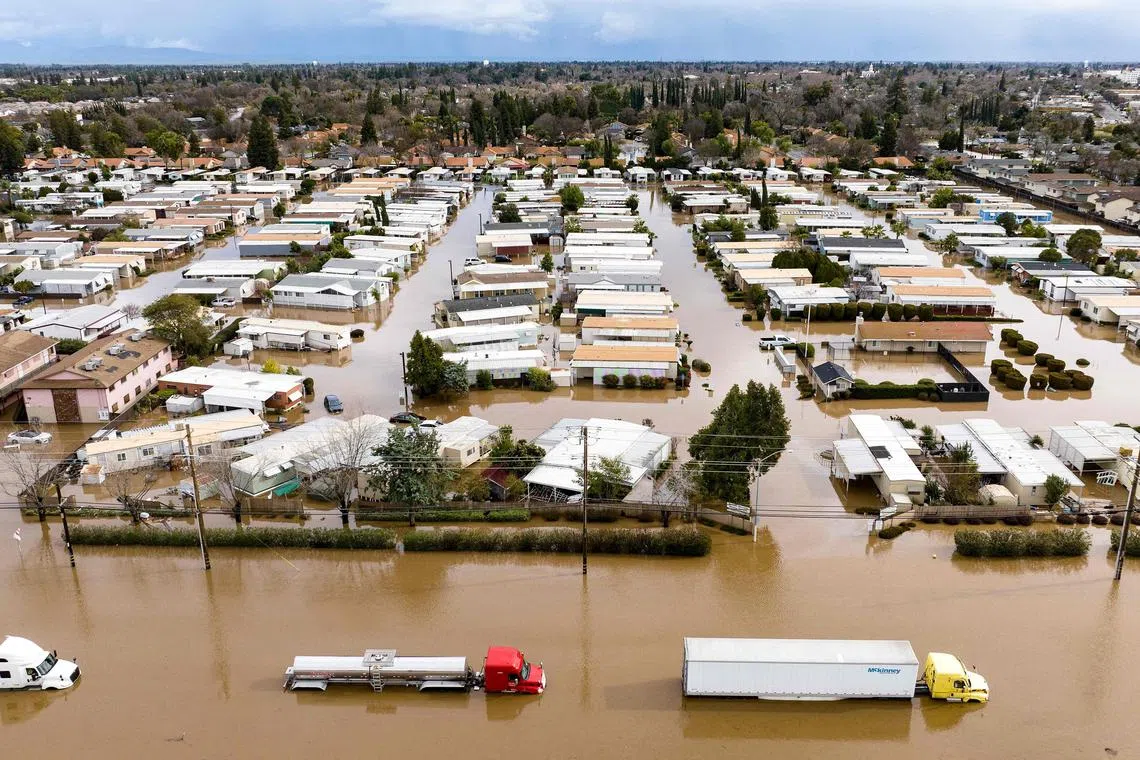 TOPSHOT - This aerial view shows a flooded neighborhood in Merced, California on January 10, 2023. - A massive storm called a bomb cyclone" by meteorologists has arrived and is expected to cause widespread flooding throughout the state. (Photo by JOSH EDELSON / AFP)