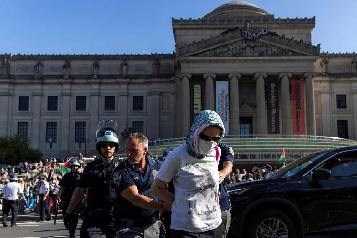 A protestor is detained by police officers in front of the Brooklyn Museum during a protest on May 31, amid the ongoing conflict between Israel and the Palestinian Islamist group Hamas.