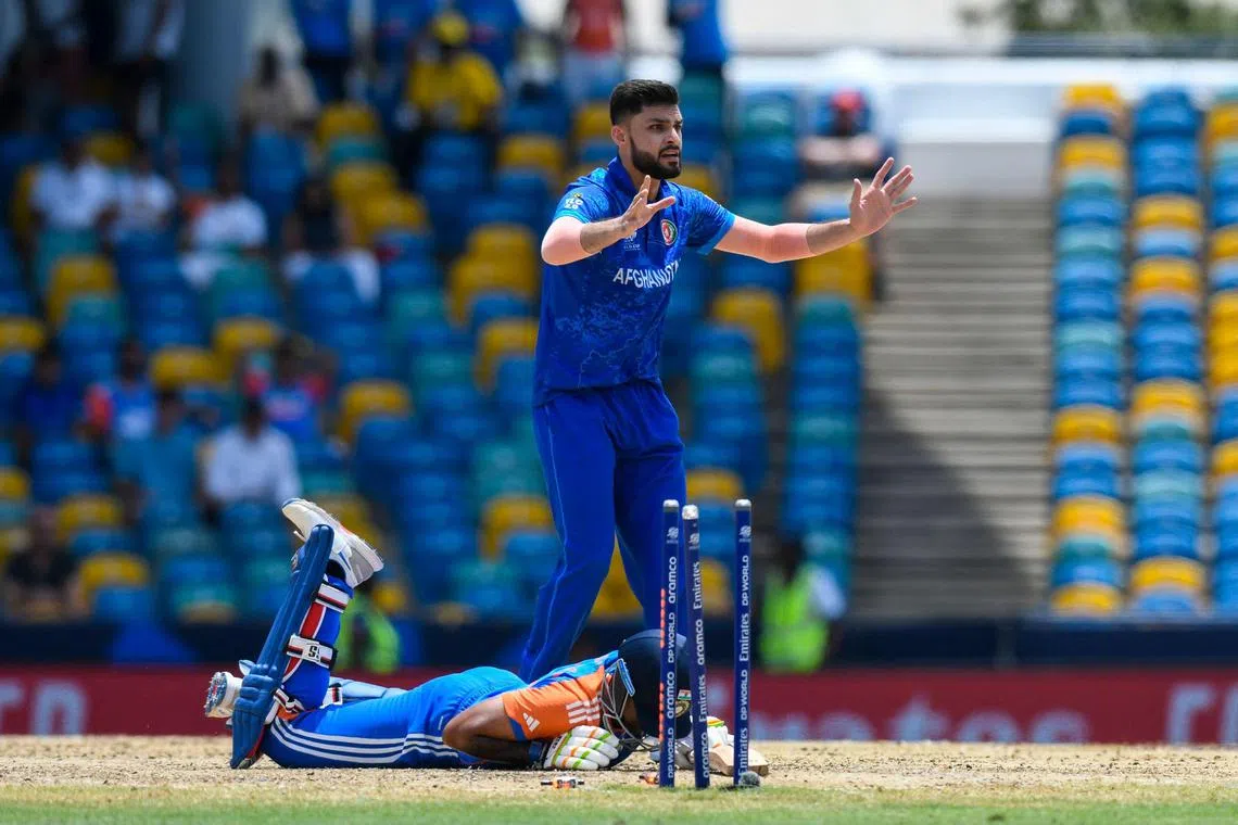 Afghanistan's Fazalhaq Farooqi appealing for a run-out against India's Suryakumar Yadav during the ICC men's Twenty20 World Cup Super Eight at Kensington Oval in Bridgetown, Barbados, on June 20, 2024.