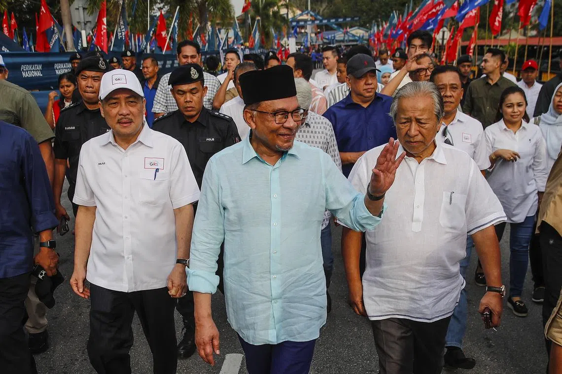 Malaysian PM Anwar Ibrahim (centre) greets supporters near the nomination center in conjunction with State Election Nomination Day in Gombak.