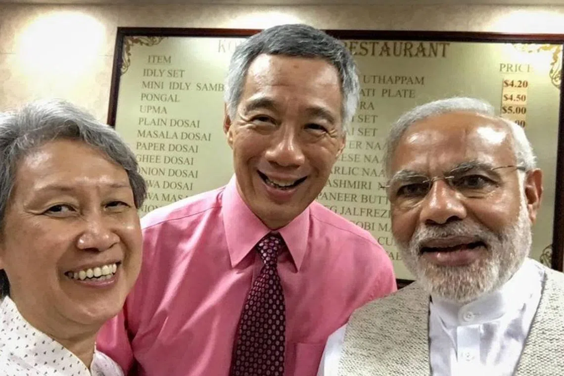 Former Prime Minister Lee Hsien Loong (centre) and his wife Ho Ching (left) taking a wefie with Indian Prime Minister Narendra Modi at Komala Vilas in November 2015.