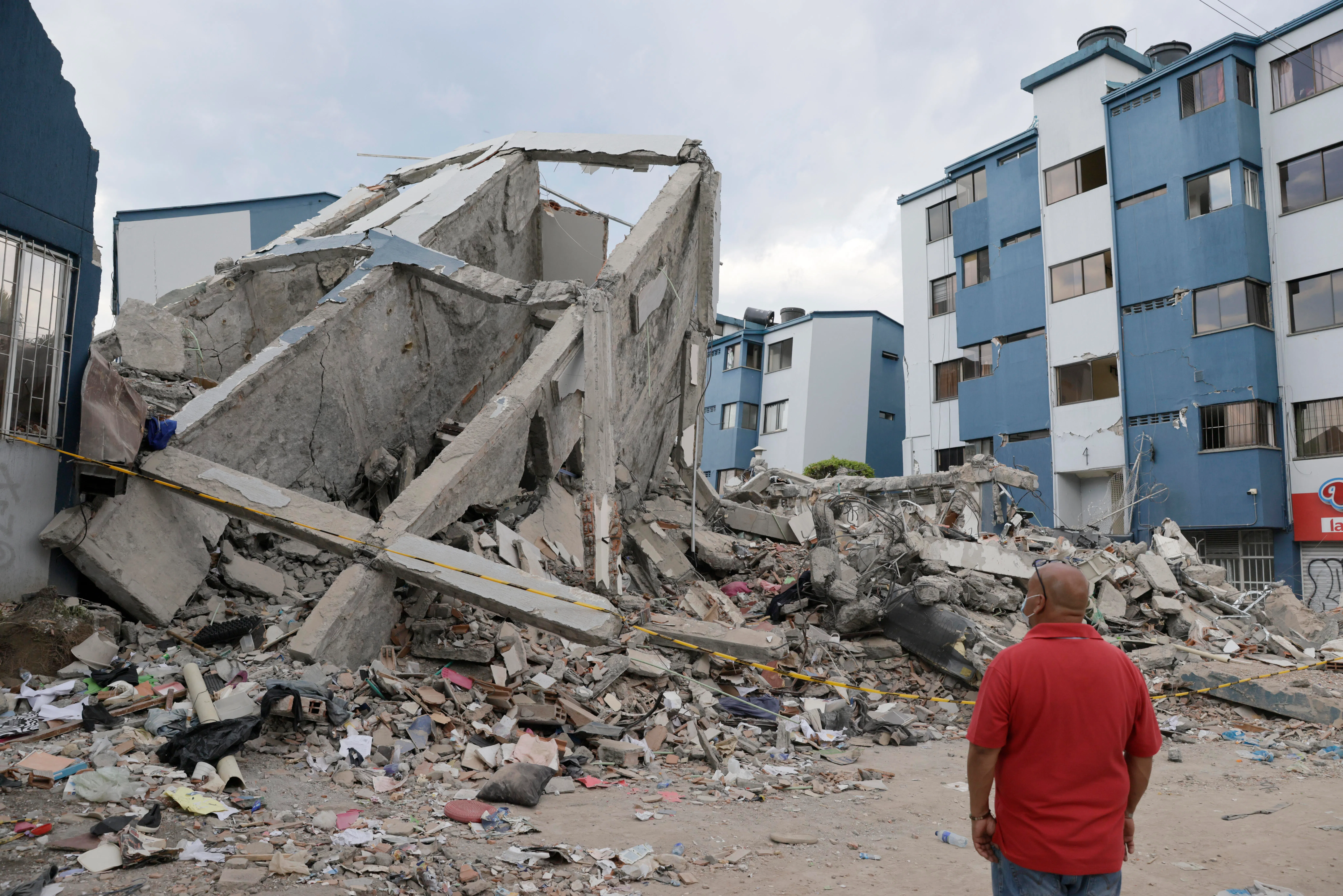 A man looking at earthquake-damaged buildings  in Pereira, Colombia, on Aug 14.