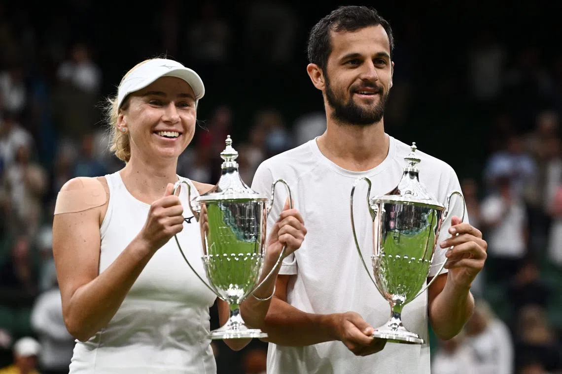 Ukraine's Lyudmyla Kichenok (left) and Croatia's Mate Pavic pose with their trophies after winning the mixed doubles final at Wimbledon.
