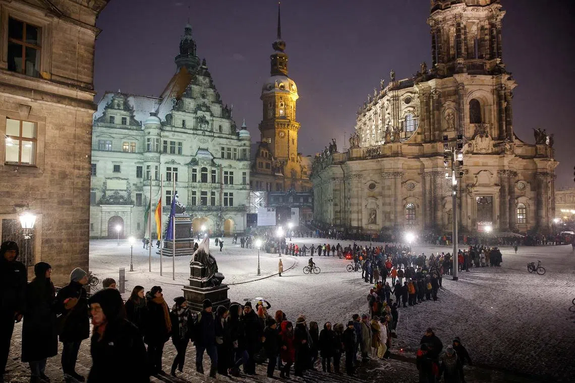 People forming a human chain during an event to commemorate the Second World War bombings of Feb 1945, in Dresden, Germany, Feb 13, 2025. 