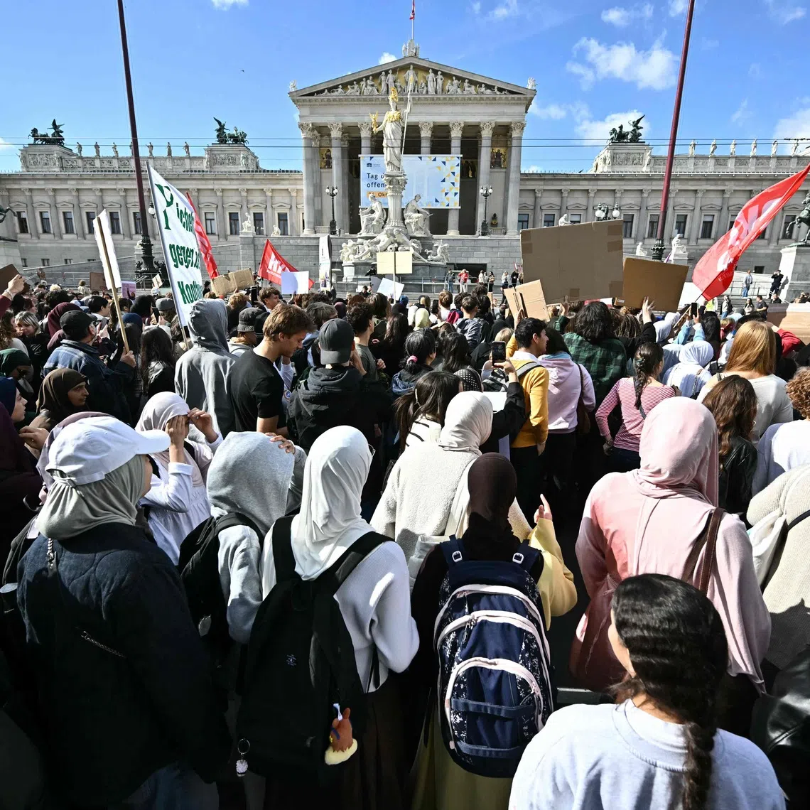 Protesters gather in front of the Austrian Parliament during a demonstration against a headscarf ban in schools on Oct 9.