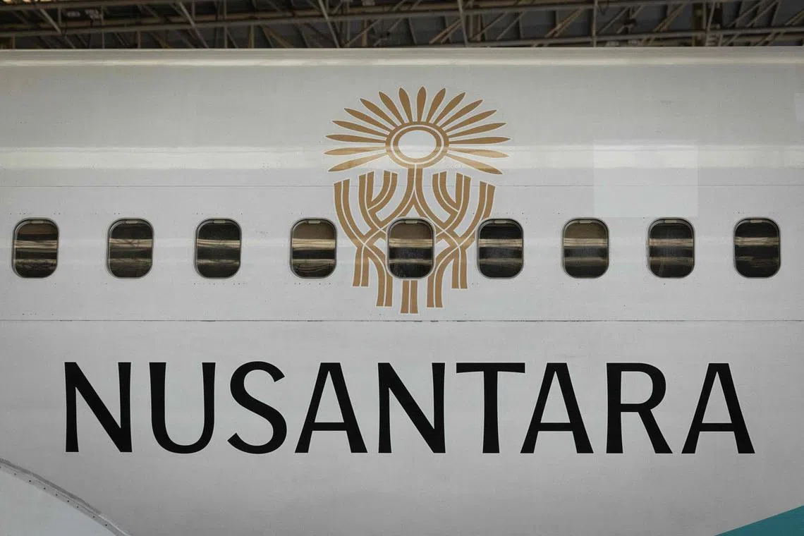 A Garuda Indonesia Boeing 737 NG plane, painted with the logo of Indonesia's future capital city of Nusantara, is seen after an unveiling ceremony at Soekarno-Hatta International Airport in Tangerang on July 26, 2024. (Photo by Yasuyoshi CHIBA / AFP)