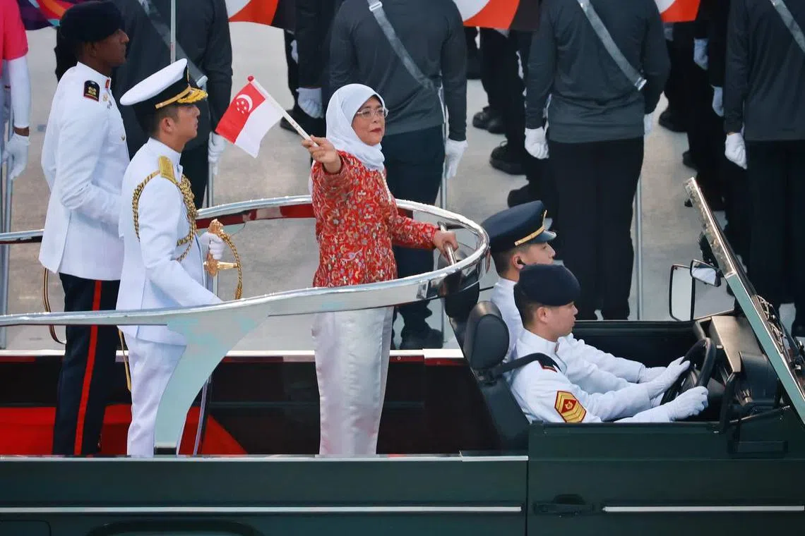 President Halimah Yacob waving to spectators during the National Day Parade  at the Padang on Aug 9, 2023. ST PHOTO: JASON QUAH