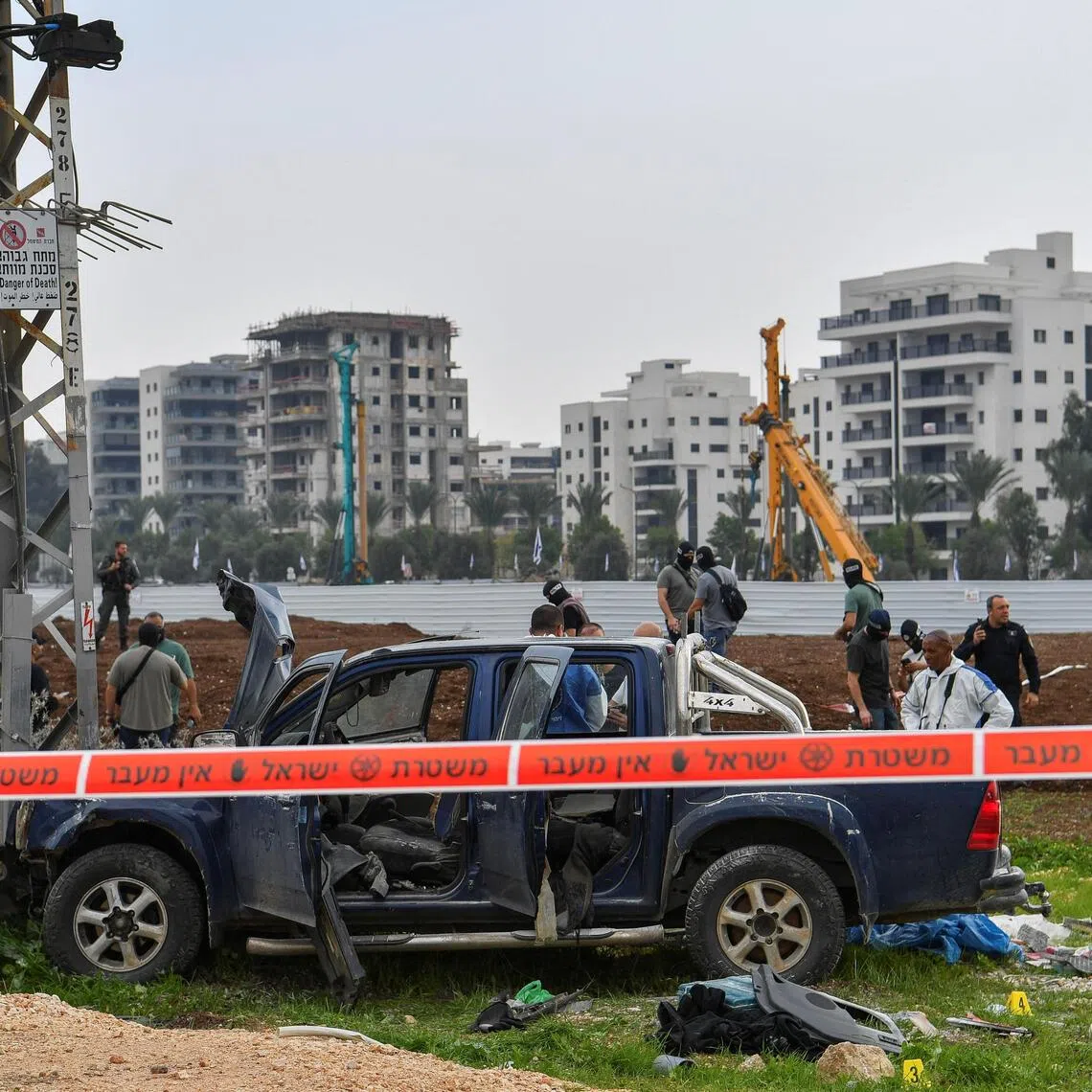 Security forces inspect the scene where a vehicle was used to kill two people in northern Israel.
