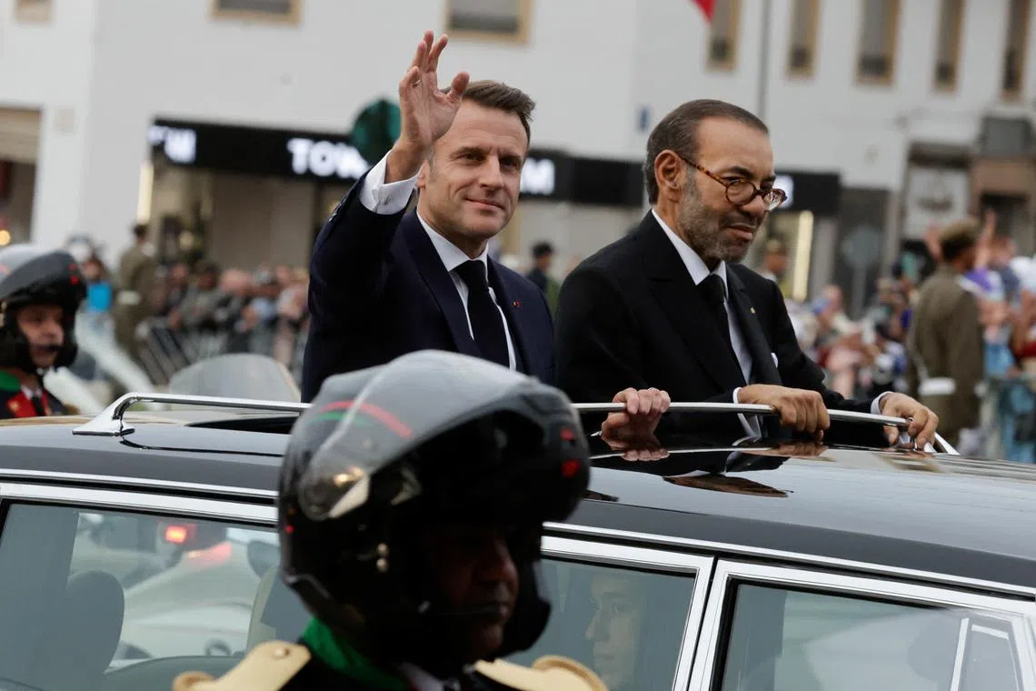 French President Emmanuel Macron greets the crowd as he tours with Morocco's King Mohammed VI on the first day of a state visit by the French president, in Rabat, Morocco October 28, 2024. REUTERS/Stringer