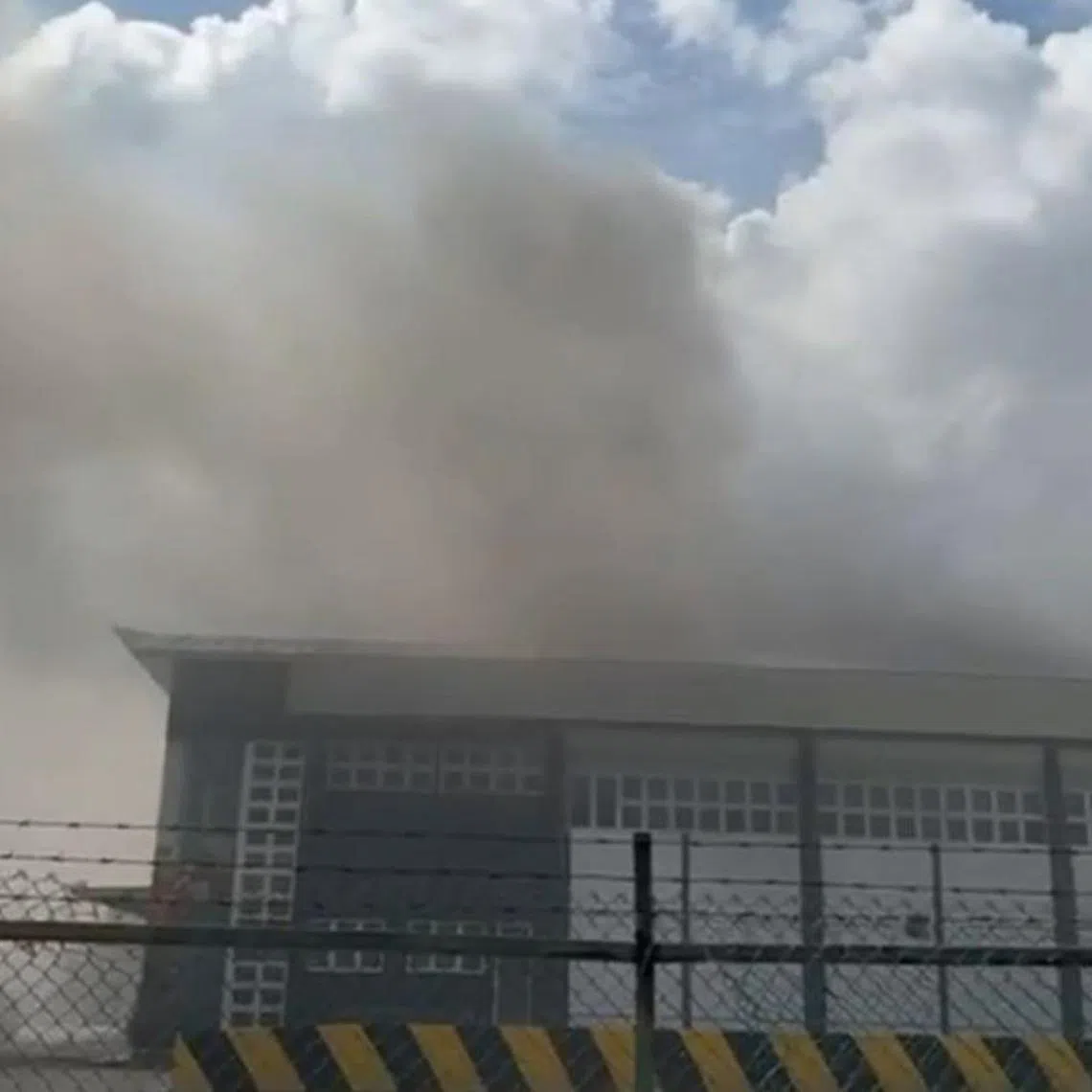 Smoke emitting from the second floor of a two-storey industrial building at Fishery Port Road on June 28, 2024.