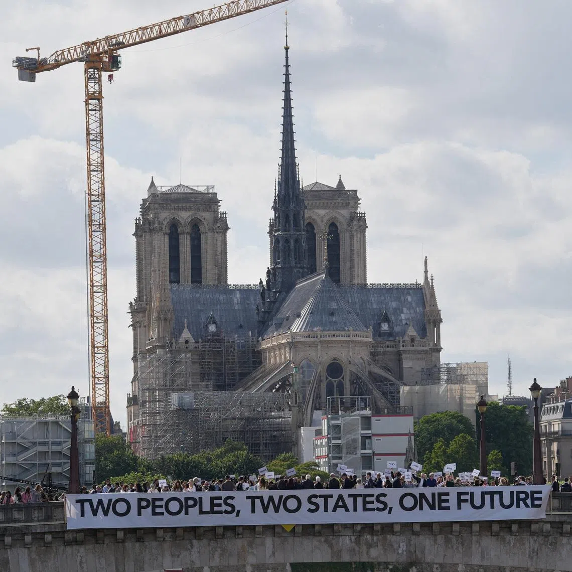 Participants in a conference with Israeli and Palestinian civil society groups supporting a two-state solution gather with placards and banners on a bridge in support of a Palestinian state, in Paris, France, June 12, 2026. Thibault Camus/Pool via REUTERS