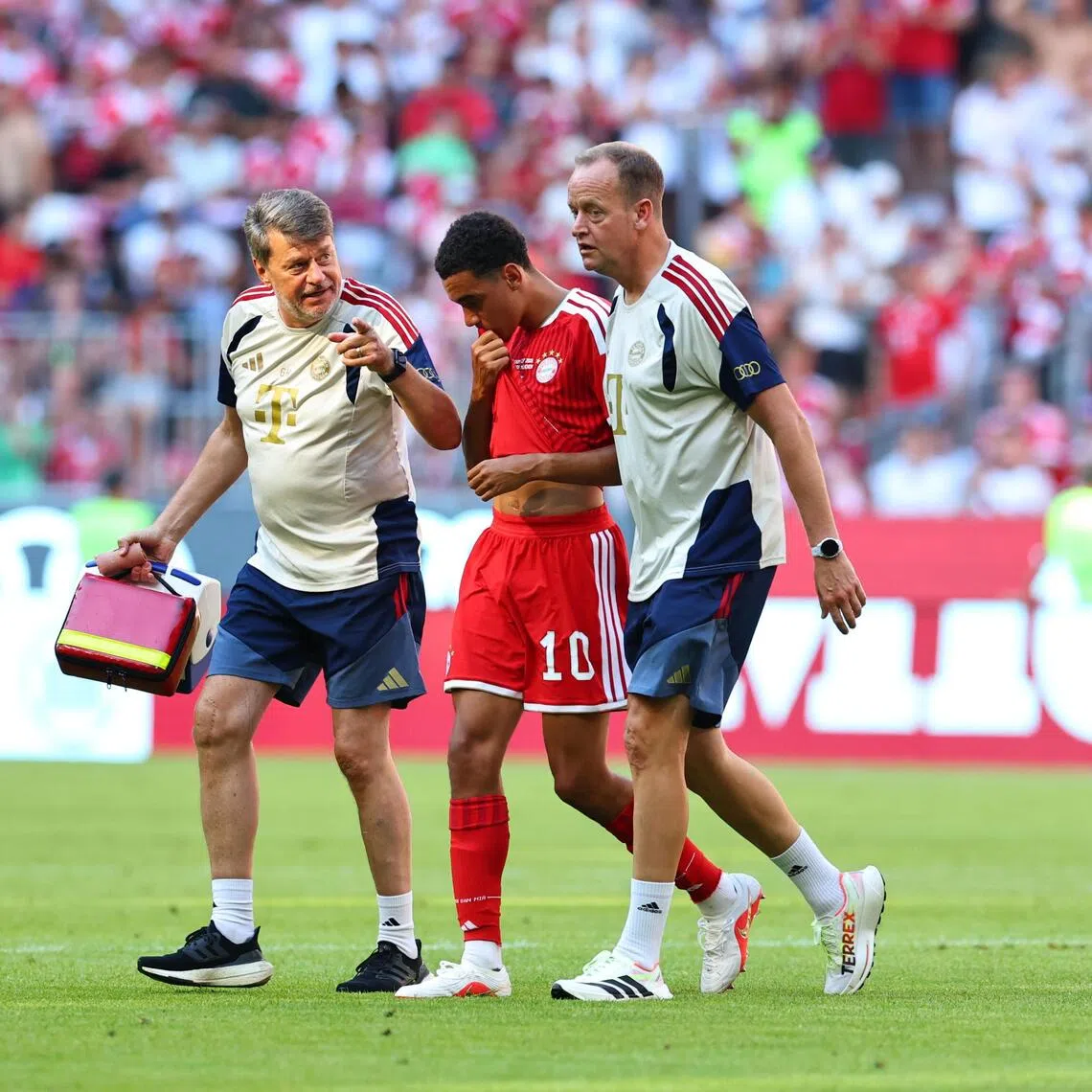 Jamal Musiala of Bayern Munich leaving the pitch during the Aug 15 match against RB Leipzig after appearing to collapse earlier.