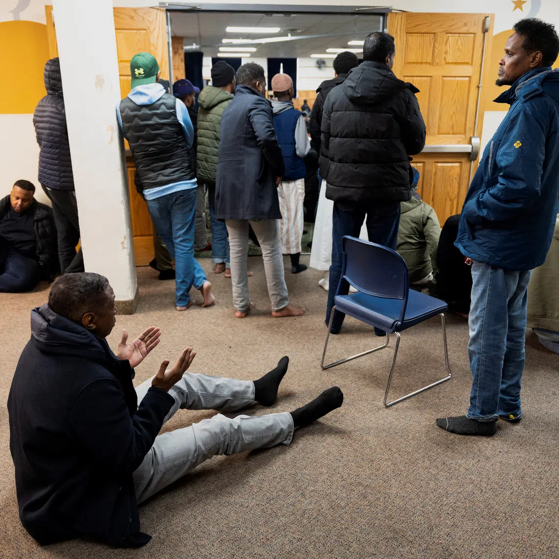 Men take part in a weekly Friday Jum’ah prayer session at Abubakar As-Saddique Islamic Center amid a reported ongoing federal immigration operation targeting the Somali community in Minneapolis, Minnesota, U.S. December 5, 2025.  REUTERS/Tim Evans/File Photo
