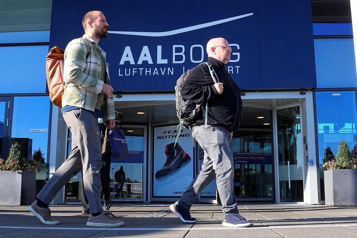 People walking at Denmark's Aalborg Airport on Sept 25. The airport reopened on Sept 26 after being closed for the second night in a row due to suspected drone activity.