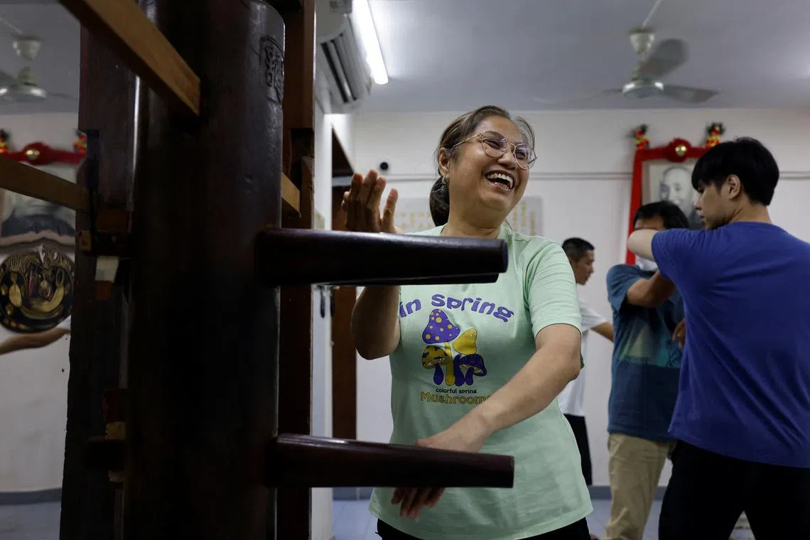 Dorothy Tam, 60, practicing on a wooden dummy known as a 'Muk Yan Jong' during a Wing Chun class on July 14. Only in 2019 did Tam overcome her initial apprehension towards Hong Kong's male-dominated martial arts scene to start learning Wing Chun, the southern Chinese style of the martial art in which Bruce Lee had trained.