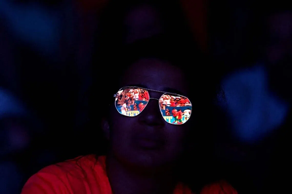 Soccer Football - FIFA World Cup 2026 - Quarter Final - France v Morocco - Fans gather in Paris - Paris, France - July 9, 2026 Morocco fan watches the match as action is reflected in her sunglasses REUTERS/Sarah Meyssonnier TPX IMAGES OF THE DAY