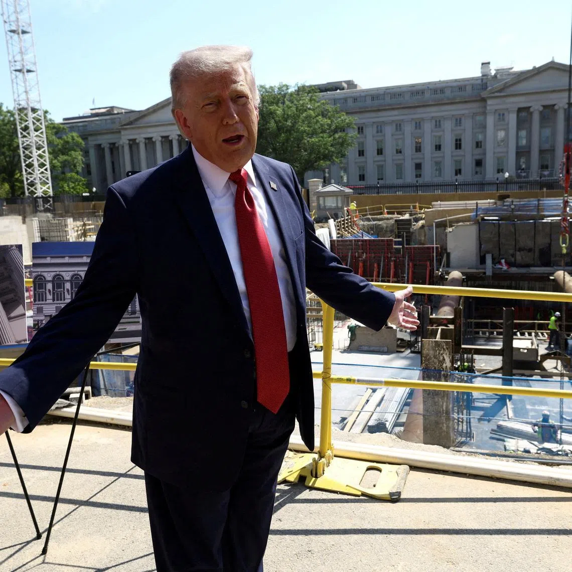 FILE PHOTO: U..S. President Donald Trump gestures at the site of ongoing construction of the planned White House ballroom in Washington, D.C., U.S., May 19, 2026. REUTERS/Kevin Lamarque        TPX IMAGES OF THE DAY/File Photo