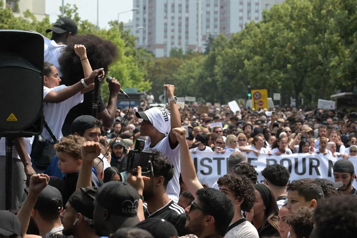 French activist Assa Traore (left) speaks from a truck during a march for teenager Nahel M, in Paris, on June 29.