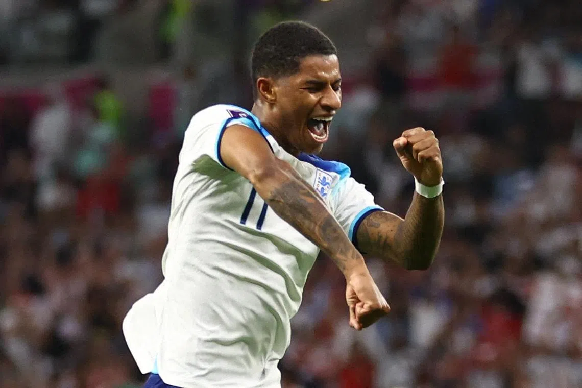 Marcus Rashford celebrates scoring England's third goal.