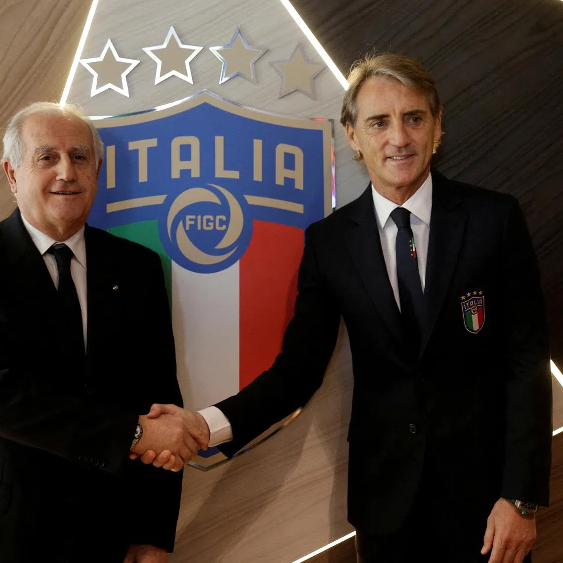 FILE PHOTO: Soccer Football - Italy - Roberto Mancini Press Conference - Coverciano, Florence, Italy - May 15, 2018    New Italy coach Roberto Mancini and Italian FA commissioner Roberto Fabbricini pose during the press conference   REUTERS/Max Rossi/File Photo