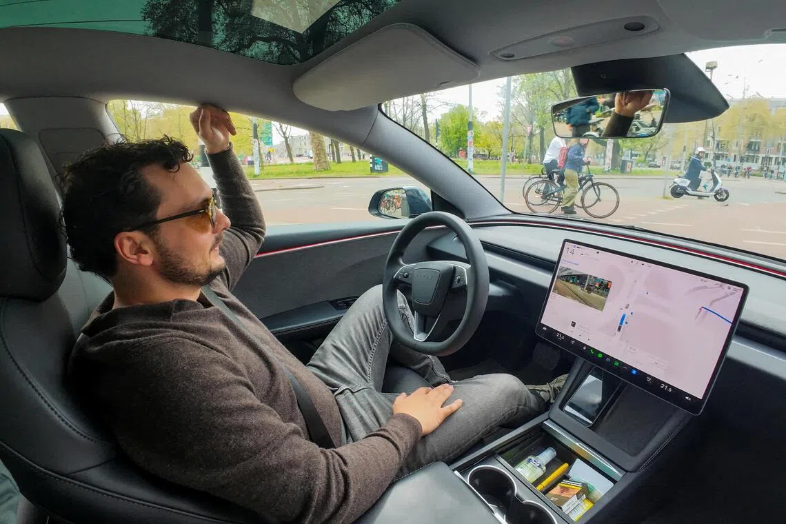 FILE PHOTO: Tesla enthusiast Kees Roelandschap drives around hands-free with his electric car, several days after Dutch regulators approved the use of Tesla's self-driving software, in Amsterdam, Netherlands, April 17, 2026. REUTERS/Bart Biesemans/File Photo