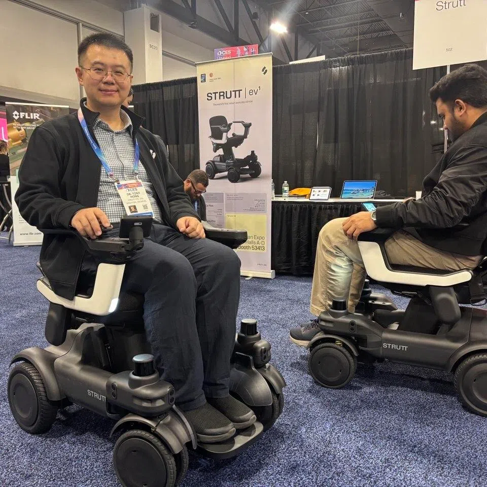 Local startup Strutt's founder Tony Hong (left), demonstrating how the ev1 works at CES 2026 in Las Vegas on Jan 4, 2026.