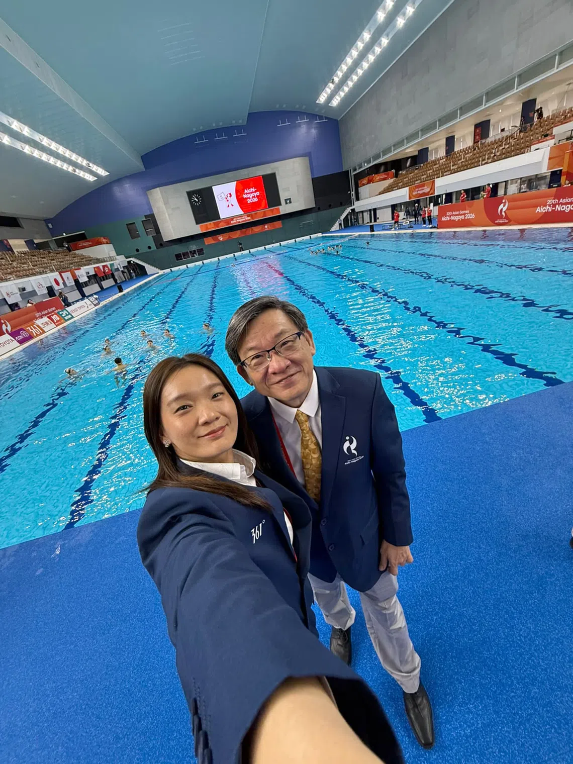 Geraldine Chew (left) and her father Steve (far right) at the Furuhashi Hironoshin Memorial Hamamatsu Swimming Centre. The father and daughter duo served as technical officials at the artistic swimming competition during these Asian Games.