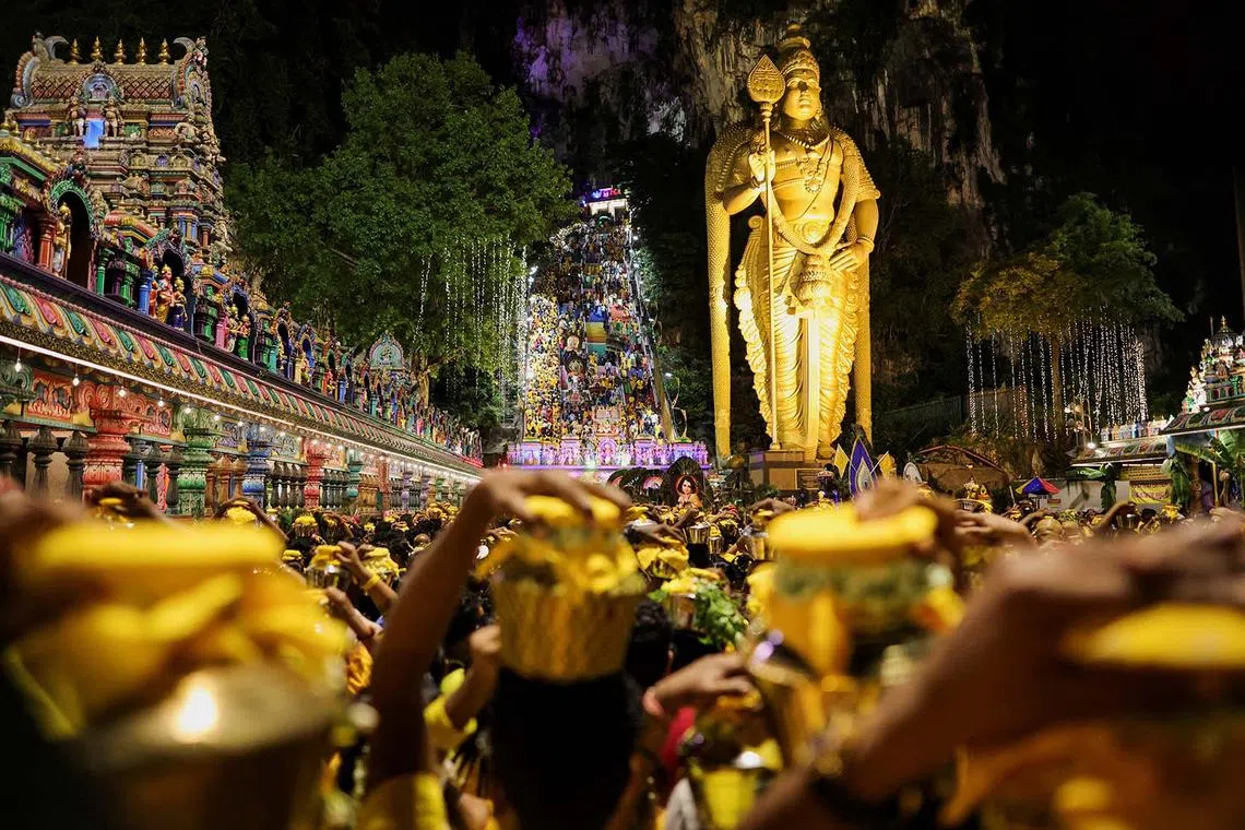 Hindu devotees carrying pots of milk as they make their way to the Sri Subramaniar Swamy Temple during the Thaipusam celebrations at Batu Caves, Malaysia, Feb 11, 2025.
